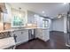 Bright, open kitchen with stainless steel appliances and dark wood flooring at 1393 Sagewood Cir, Stone Mountain, GA 30083
