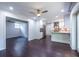 Modern kitchen boasts stainless steel appliances, white cabinetry, and a breakfast bar with dark hardwood floors at 1393 Sagewood Cir, Stone Mountain, GA 30083
