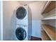 Convenient laundry area featuring stacked washer and dryer with shelving at 1393 Sagewood Cir, Stone Mountain, GA 30083