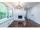 Cozy living room featuring a fireplace, hardwood floors, and a large window at 1393 Sagewood Cir, Stone Mountain, GA 30083