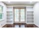 Detailed view of built-in bookshelves surrounding a set of french doors in a living room at 1393 Sagewood Cir, Stone Mountain, GA 30083