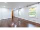 Spacious room featuring hardwood floors, large windows, and modern light fixtures at 1393 Sagewood Cir, Stone Mountain, GA 30083