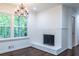 Bright living room features a fireplace, chandelier, hardwood floors, and natural light at 1393 Sagewood Cir, Stone Mountain, GA 30083