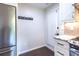 Modern mud room with stainless steel refrigerator and door leading to the outside at 1393 Sagewood Cir, Stone Mountain, GA 30083