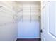 Walk-in closet with built-in white wire shelving provides ample storage space at 1393 Sagewood Cir, Stone Mountain, GA 30083