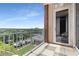 Balcony with cozy seating and a view of the lush greenery and community pool at 1820 Peachtree Nw St # 804, Atlanta, GA 30309