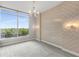 Bedroom featuring a large window with exterior views, stylish lighting, and accent wall at 1820 Peachtree Nw St # 804, Atlanta, GA 30309