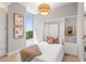 This bedroom features natural light from the large window and a stylish light fixture at 1820 Peachtree Nw St # 804, Atlanta, GA 30309