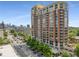 Scenic view of the high-rise building featuring a mix of brick and large windows, with the city skyline at 1820 Peachtree Nw St # 804, Atlanta, GA 30309
