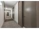 Long hallway with patterned carpeting, modern wall sconces, and neutral tones, leading to rooms at 1820 Peachtree Nw St # 804, Atlanta, GA 30309