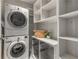 A spacious laundry room with washer, dryer, storage shelves, and organization at 1820 Peachtree Nw St # 804, Atlanta, GA 30309