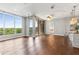 Living room with hardwood floors, natural light, modern lighting, and a kitchen and bedroom just off the space at 1820 Peachtree Nw St # 804, Atlanta, GA 30309