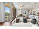 Sunlit living space with balcony, sleek sofa, and adjacent dining area perfect for relaxation at 1820 Peachtree Nw St # 804, Atlanta, GA 30309