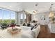 Bright living room with large windows, modern furniture, and access to a balcony showcasing the beautiful outdoor view at 1820 Peachtree Nw St # 804, Atlanta, GA 30309