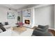 Inviting living room featuring a fireplace with an elegant tile surround and patterned accent chairs at 1820 Peachtree Nw St # 804, Atlanta, GA 30309