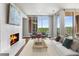 Cozy living room featuring a modern fireplace, plush seating, and large windows with scenic views at 1820 Peachtree Nw St # 804, Atlanta, GA 30309