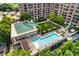 Aerial view of the sparkling community pool surrounded by lush green landscaping and seating at 1820 Peachtree Nw St # 804, Atlanta, GA 30309