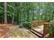 Enjoy the private backyard from the deck with stepping stones leading to the seating area at 2045 Barrett Downs Dr, Cumming, GA 30040