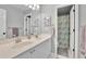 Bathroom featuring double vanity sinks, mirror and shower with blue mosaic curtain at 2045 Barrett Downs Dr, Cumming, GA 30040