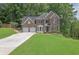 Beautiful two-story brick home featuring an attached two-car garage and a well-manicured front lawn at 2045 Barrett Downs Dr, Cumming, GA 30040