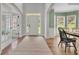 Bright foyer with high ceilings, hardwood floors, and a front door with sidelights and transom window at 2045 Barrett Downs Dr, Cumming, GA 30040