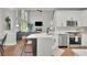 Bright open floorplan kitchen with view of great room; features stainless appliances and island at 2045 Barrett Downs Dr, Cumming, GA 30040