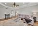 Spacious living room with tray ceilings, hardwood floors, and natural light at 2045 Barrett Downs Dr, Cumming, GA 30040