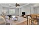 Inviting living room featuring hardwood floors, neutral walls, and a large comfortable sofa at 2045 Barrett Downs Dr, Cumming, GA 30040