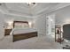 Spacious main bedroom features a tray ceiling, ensuite bath, and plenty of room to relax at 2045 Barrett Downs Dr, Cumming, GA 30040