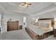Large main bedroom featuring a tray ceiling, lots of space, and comfortable carpeting at 2045 Barrett Downs Dr, Cumming, GA 30040