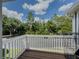 Balcony overlooking green trees with white railings, ideal for outdoor relaxation at 907 Olde Mill Ln, Norcross, GA 30093