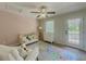 The bedroom is decorated with a crib and a door to the outside at 907 Olde Mill Ln, Norcross, GA 30093