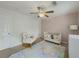 Cozy bedroom featuring pastel color accents and a ceiling fan for added comfort at 907 Olde Mill Ln, Norcross, GA 30093