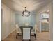 Cozy dining room with modern lighting fixture adjacent to the kitchen for seamless dining at 907 Olde Mill Ln, Norcross, GA 30093