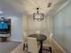 Charming dining area featuring a modern light fixture and seamless flow to the kitchen and living room at 907 Olde Mill Ln, Norcross, GA 30093