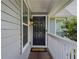 Charming home entrance with a classic black door, decorative light fixture, and welcoming porch at 907 Olde Mill Ln, Norcross, GA 30093