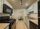 This kitchen offers a gas cooktop, microwave, laminate countertops, and storage space at 907 Olde Mill Ln, Norcross, GA 30093