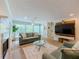 Bright, airy living room with large windows, a fireplace, and a modern media center at 907 Olde Mill Ln, Norcross, GA 30093