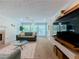 Stylish living room with a fireplace, a modern media center, and abundant natural light at 907 Olde Mill Ln, Norcross, GA 30093