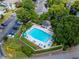 Community pool with lounge chairs and landscaping, surrounded by trees and parking at 907 Olde Mill Ln, Norcross, GA 30093