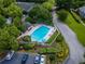 Aerial view of community pool surrounded by lush landscaping and lounge chairs at 907 Olde Mill Ln, Norcross, GA 30093