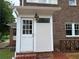 Brick home's exterior with a white door, light fixture, and small porch with brick flooring at 1098 Oakdale Ne Rd, Atlanta, GA 30307