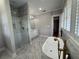 Bright bathroom with marble floors, soaking tub, glass shower, and adjacent vanity at 1098 Oakdale Ne Rd, Atlanta, GA 30307