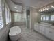 Bright bathroom with marble floors, soaking tub, dual sink vanity, and glass shower at 1098 Oakdale Ne Rd, Atlanta, GA 30307