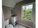 Bright bathroom with white vanity, marble floors, and a large window offering garden views at 1098 Oakdale Ne Rd, Atlanta, GA 30307