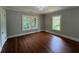 Light-filled bedroom features hardwood floors, neutral paint, and a view of the outdoors at 1098 Oakdale Ne Rd, Atlanta, GA 30307