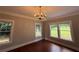 Bedroom with hardwood floors, two windows, and a decorative chandelier at 1098 Oakdale Ne Rd, Atlanta, GA 30307