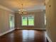 Elegant dining room with hardwood floors, chandelier, and large windows offering scenic views at 1098 Oakdale Ne Rd, Atlanta, GA 30307