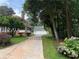 Long driveway leading to a brick home with mature landscaping and a detached garage at 1098 Oakdale Ne Rd, Atlanta, GA 30307