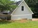 Side view of a light gray home with a gabled roof, white trim, and a small yard at 1098 Oakdale Ne Rd, Atlanta, GA 30307